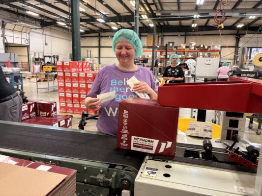 Woman with disability labeling boxes at BCI Packaging